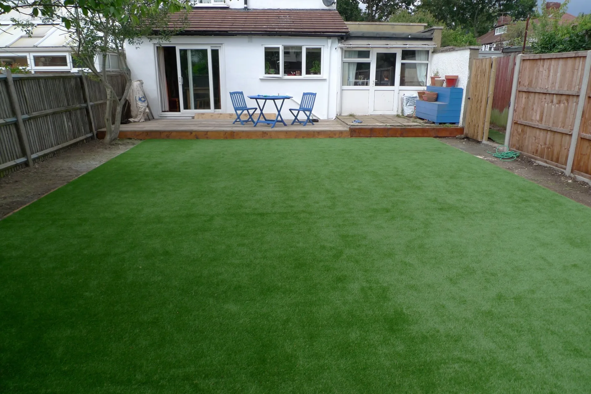 Artificial turf backyard installation with fenced pet area