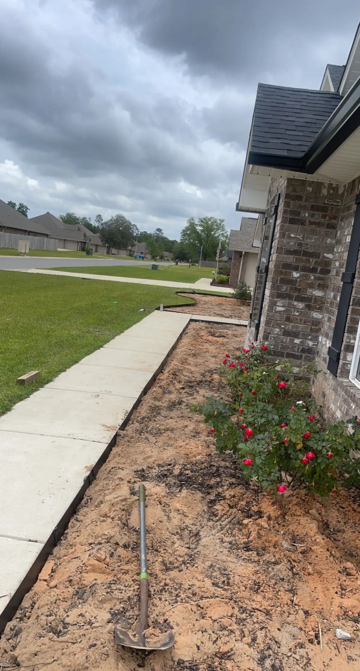 Fresh mulch and plantings in a completed landscape bed